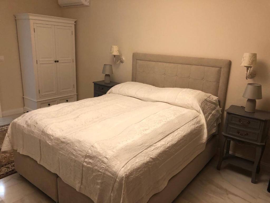 Bright bedroom with wardrobe and bedside tables