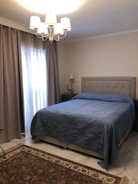 Bedroom with large window and curtains